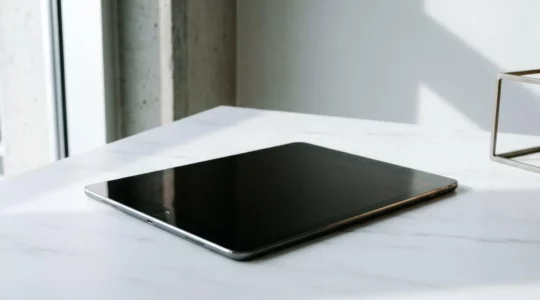 Professional tablet device positioned in a modern minimalist workspace showing sophisticated hardware architecture without visible text or screens
